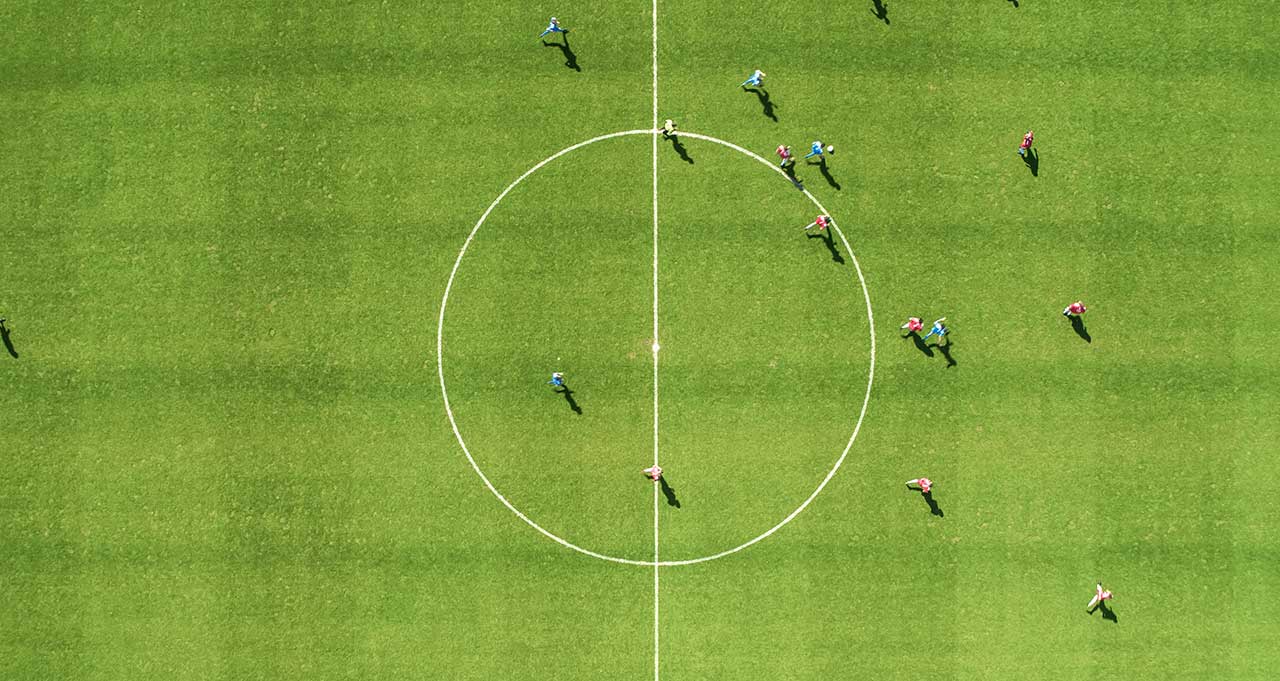Aerial Top Down View of Soccer Football Field and Two Professional Teams Playing