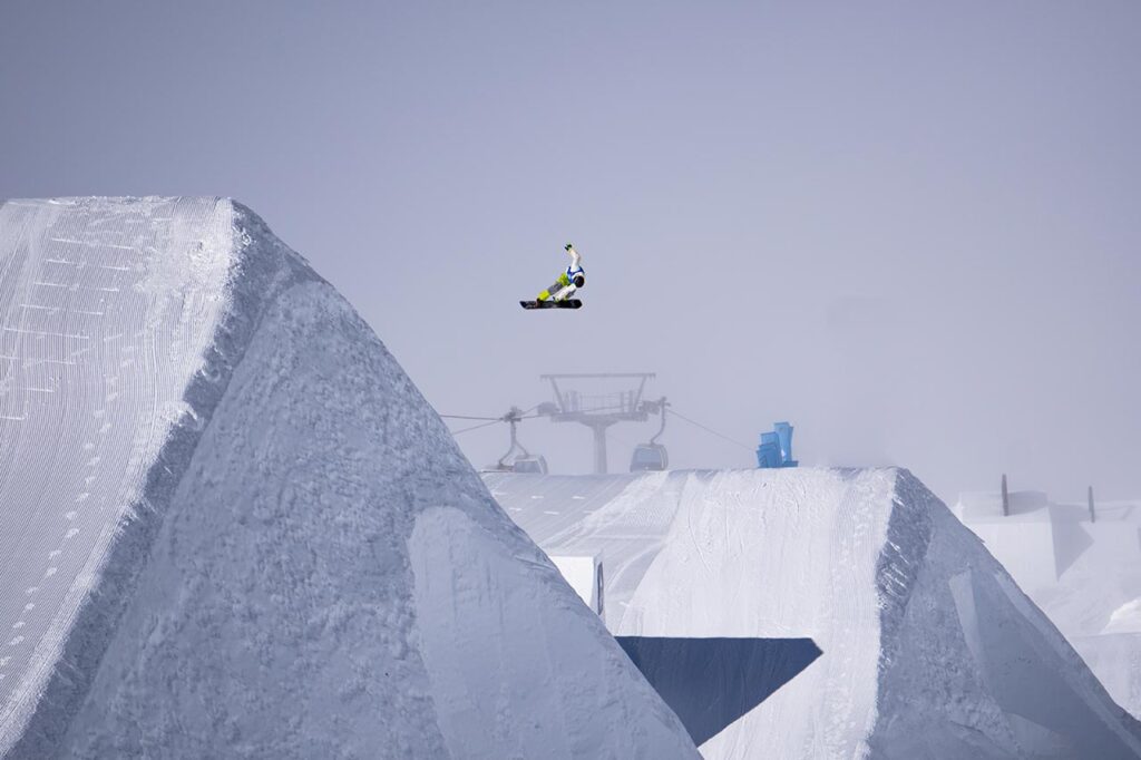 Snowboarder showing off at the Snowpark on a cloudy day